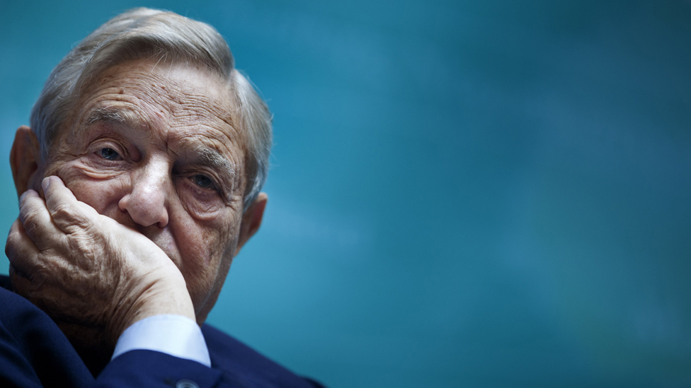 Elderly man with contemplative expression against blue background