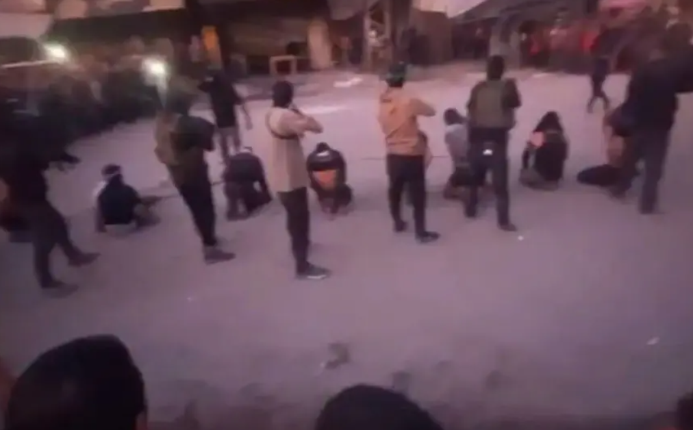 Group of people gathered in an open area at dusk